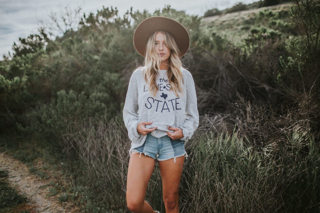 Payton Sartain of Hustle + Halcyon wears a Texas Top from Livy Lu